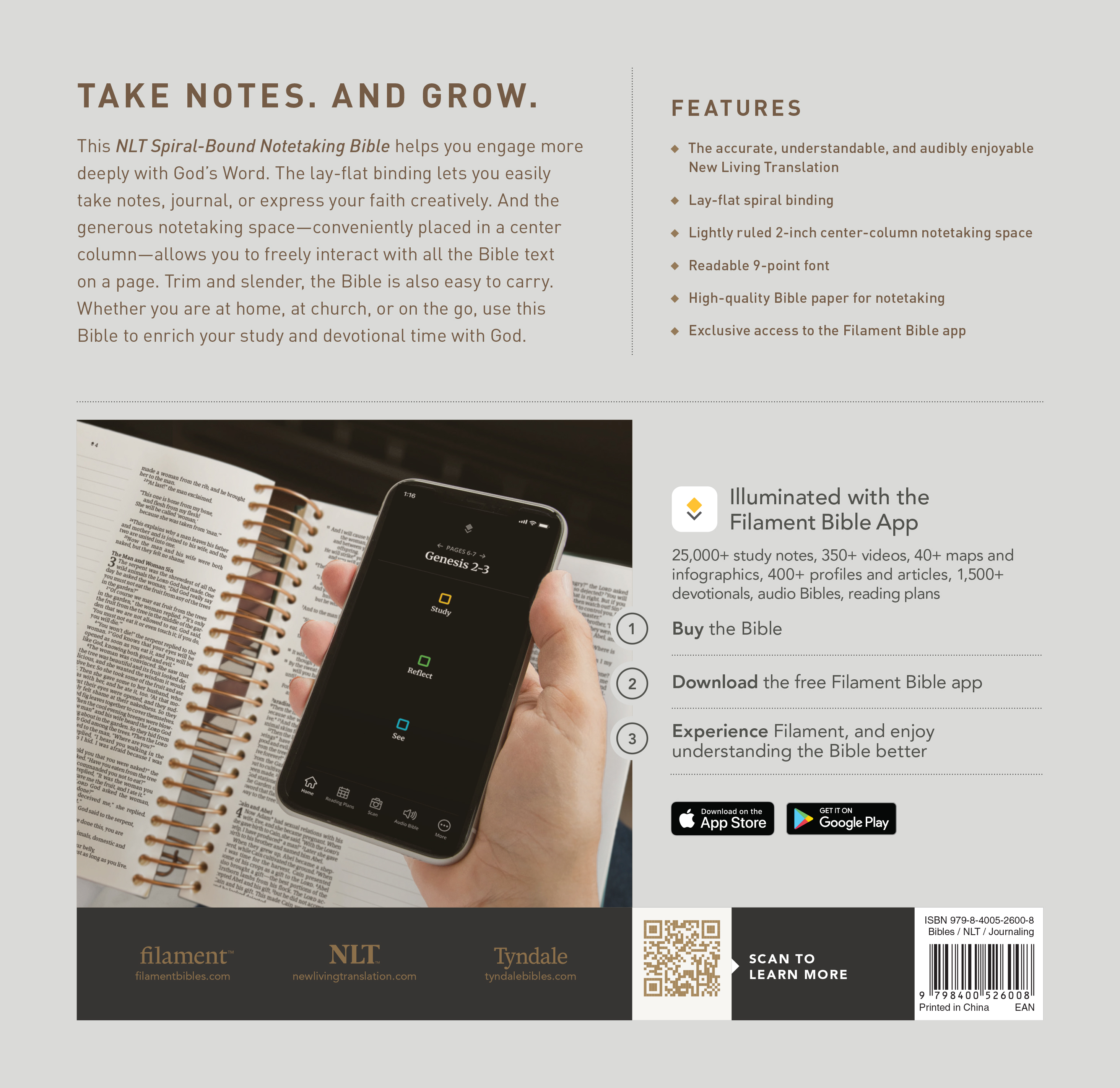 Open spiral-bound Bible beside a phone showing the Filament Bible app